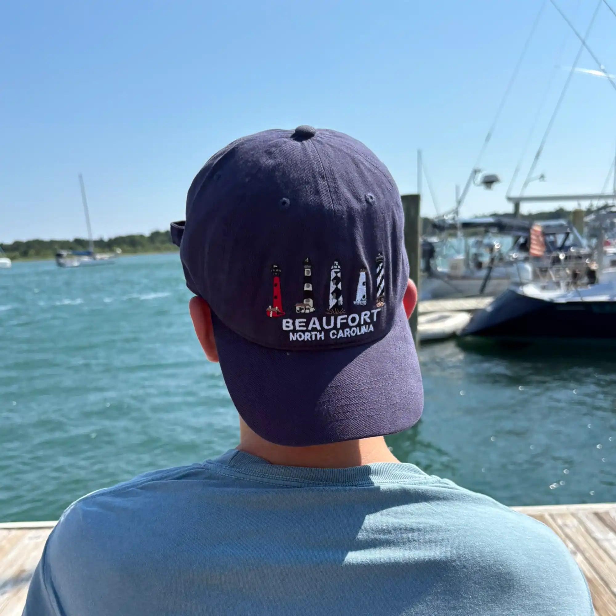 Beaufort, NC Lighthouses 100% Cotton Hat in Navy, worn by a model